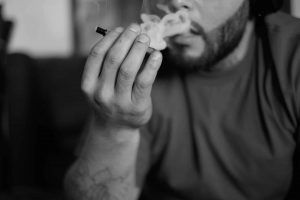 Man smokes a marijuana blunt spliff