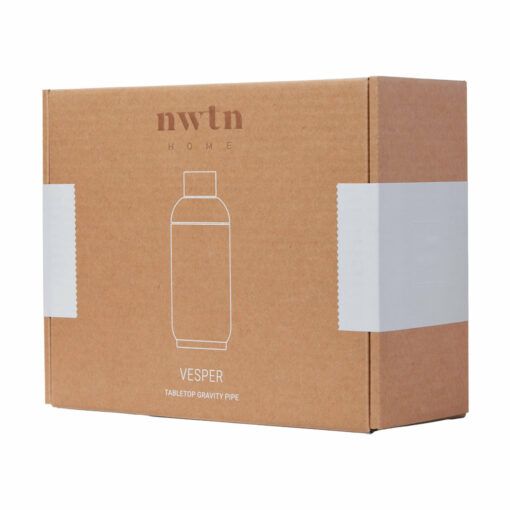 A brown cardboard box labeled NWTN Home with a simple bottle line drawing and Vesper Gravity Pipe text on the front, closed and sealed with white tape on both sides.