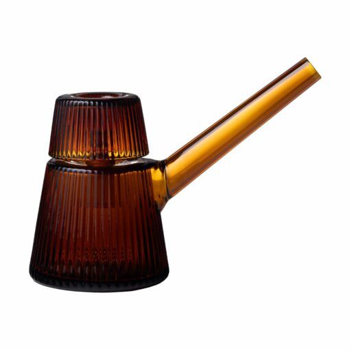 The NWTN Home Deco Bubbler is a modern amber glass pitcher with a long spout and ribbed texture, topped by an inverted matching glass. Its sleek, minimalistic design stands out against a white background.