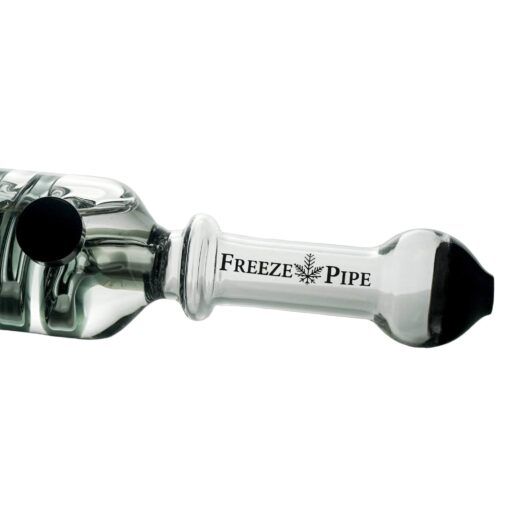 Close-up of The Freeze Pipe, a transparent glass smoking pipe featuring a snowflake logo, branding on the side, and a sleek black accent near the bowl.