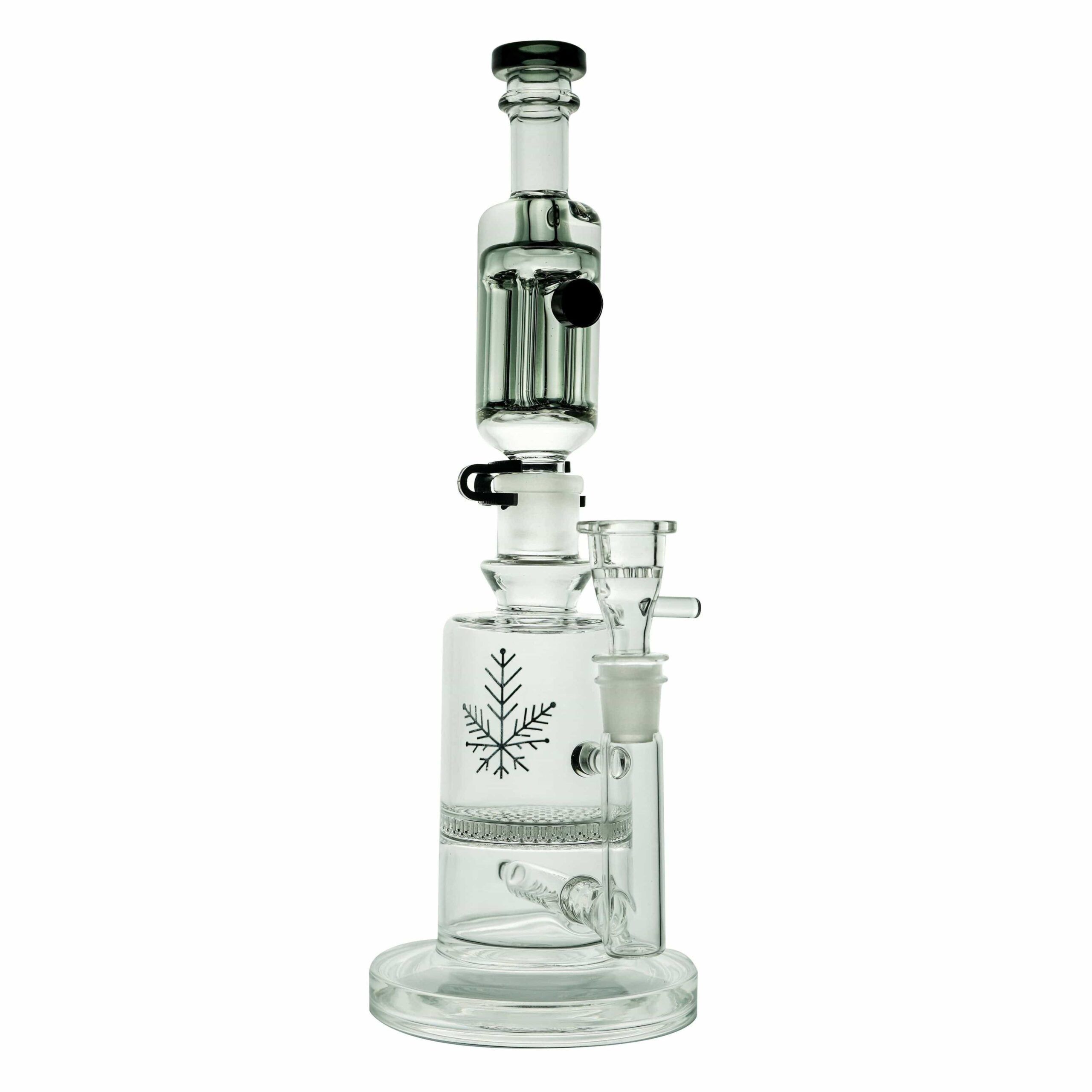 The Freeze Pipe Mini Bong features clear glass, multiple chambers, a black-trimmed mouthpiece, and a snowflake design. Its sturdy round base holds a removable bowl and percolator for smooth, cool hits.