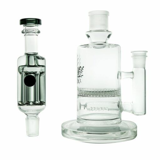 Against a white background, two clear glass smoking accessories are displayed: the cylindrical Freeze Pipe percolator on the right and the Freeze Pipe Mini Bong with a black accent on the left.
