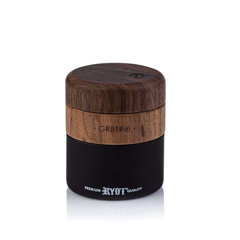 The WOOD GR8TR WITH JAR BODY is a cylindrical wood grinder featuring a wooden top labeled GR8TR and a black base marked RYOT PREMIUM QUALITY, displayed against a white background.