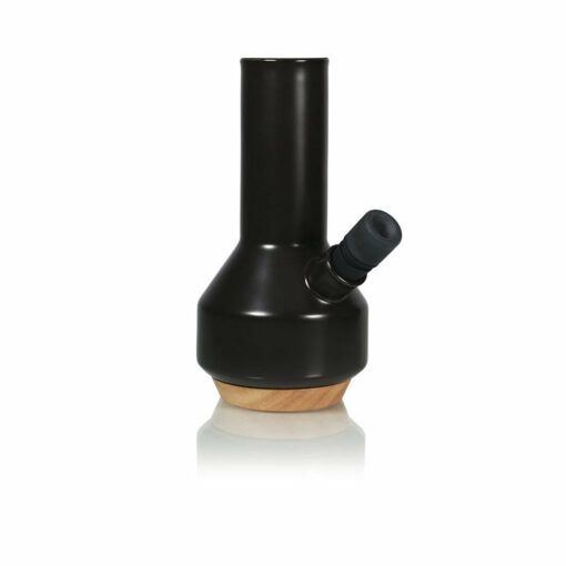 The RYOT CERAMIC MAPLE TRAVELLER PIPE features a sleek black ceramic body with a cylindrical neck, side mouthpiece, and natural maple wood base—ideal for stylish travellers—shown against a white background.