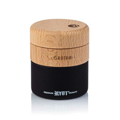 The WOOD GR8TR WITH JAR BODY features a cylindrical jar, a light wood GR8TR® top engraved with a logo, and a matte black base that reads PREMIUM RYOT QUALITY in white. "GR8TR®" is also printed on the side.