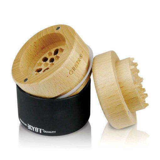 The WOOD GR8TR WITH JAR BODY features a two-part wooden herb grinder—one piece sits on a sleek black jar body while the other leans beside it, displaying sharp GR8TR teeth inside for efficient grinding.
