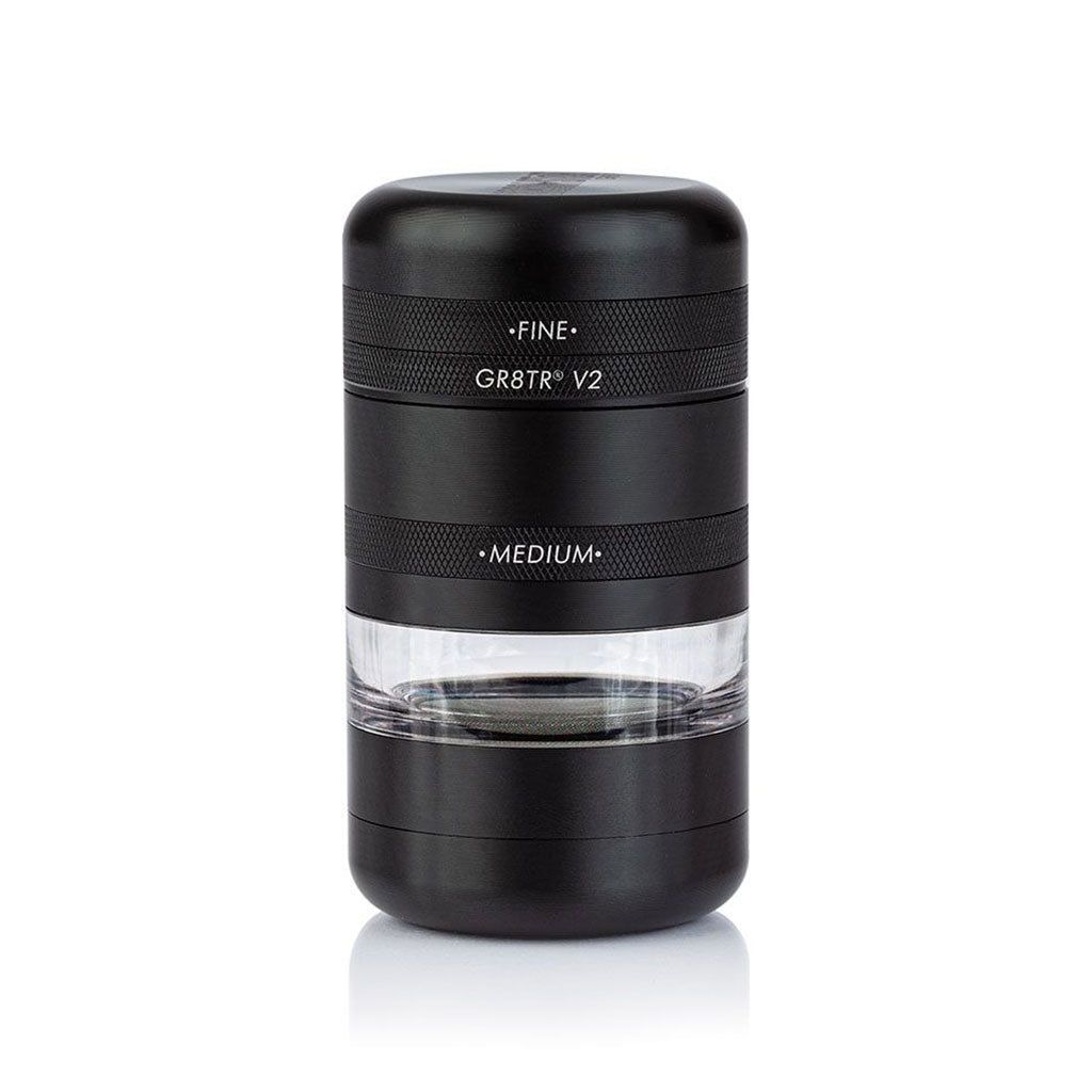 A black RYOT GR8TR Jar Body Grinder (V2) with FINE and MEDIUM sections, featuring a clear jar chamber to view contents, stands upright on a white background.