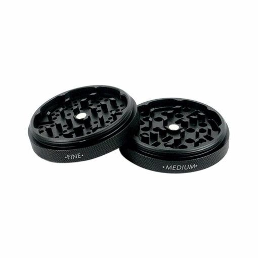 Two black circular RYOT GR8TR JAR BODY GRINDER pieces are shown side by side, labeled “FINE” and “MEDIUM,” with textured sides and distinct grinding teeth patterns on top.