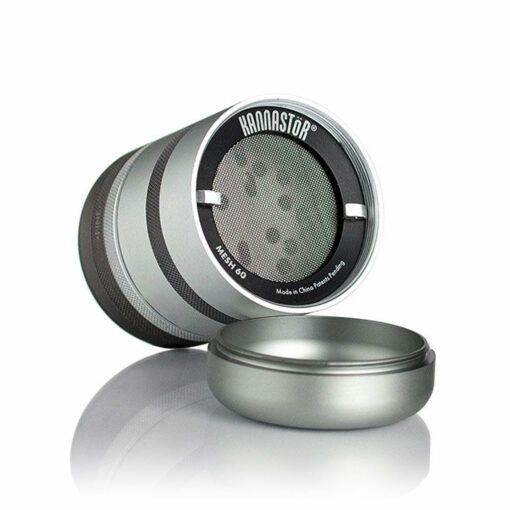 A metallic, cylindrical RYOT GR8TR JAR BODY GRINDER with a mesh screen and detached lid is displayed on a white background. The brand logo appears on the top part of the grinder.