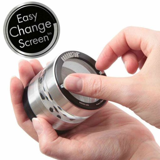 A person’s hands are shown changing a mesh screen on a cylindrical RYOT 4PC JAR BODY GRINDER. An inset label reads “Easy Change Screen™” in white text on a black circular background.