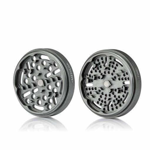 Two gray RYOT GR8TR Jar Body Grinder pieces with sharp teeth and holes are shown side by side on a white background—ideal for efficient herb grinding.