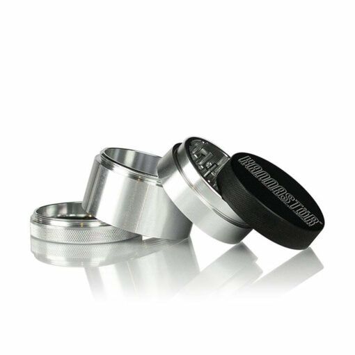 Four pieces of the RYOT 4PC SOLID BODY GRINDERS are shown apart: the black top lid, silver teeth section, and mesh screen—perfect for fans of solid body grinders.