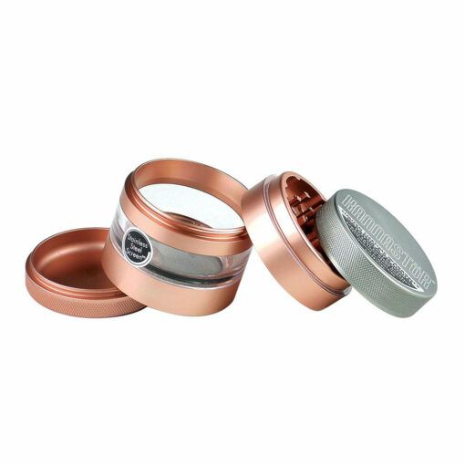 The RYOT 4PC JAR BODY GRINDERS is shown disassembled on a white background, featuring a metallic four-piece design with a see-through middle, mesh screen, grinding teeth, and a magnetic lid.