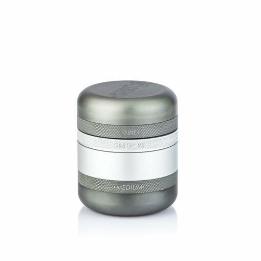 The RYOT GR8TR SOLID BODY GRINDER is a cylindrical grinder with a matte gray finish and a silver band around the middle labeled FINE and MEDIUM for grind settings, shown against a plain white background.