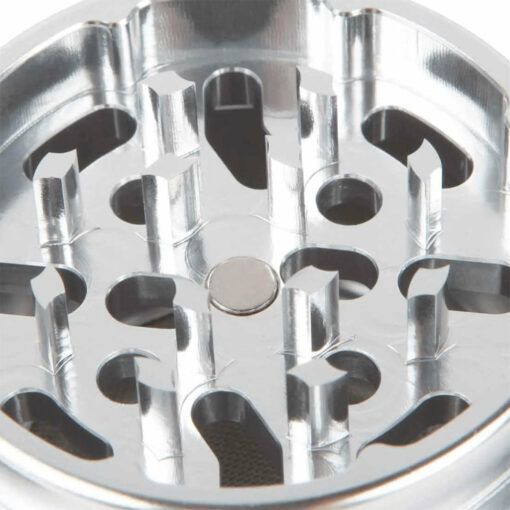 Close-up of the RYOT 4PC JAR BODY GRINDER’s interior reveals sharp, jagged teeth and a magnetic center, showcasing this grinder's efficient herb or spice grinding capability.