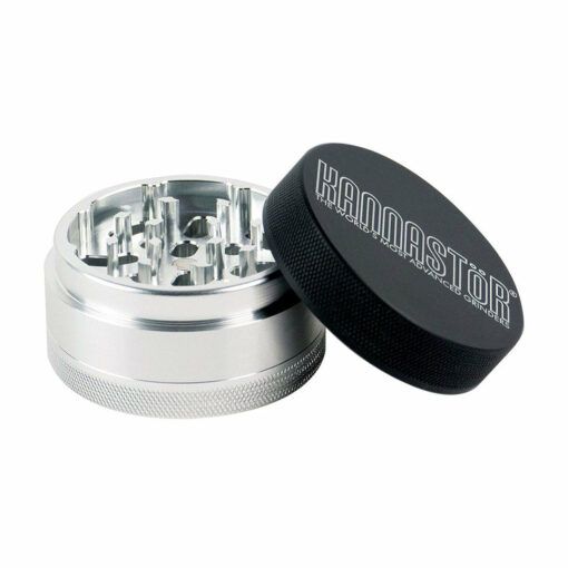 A silver and black metal RYOT 4PC JAR BODY GRINDER with sharp teeth inside is shown with its slightly open black lid displaying the RYOT logo.