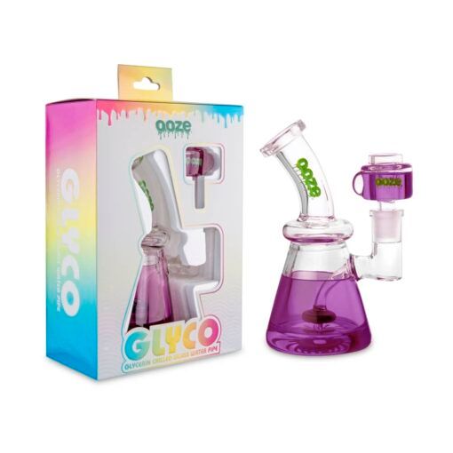 The Ooze Glyco Bong Glycerin Chilled Glass Water Pipe sits next to its vibrant box, which features the product image and bold GLYCO branding—ideal for anyone seeking a cool, glycerin-chilled smoking experience.