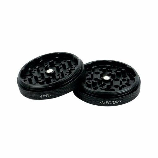 Two black circular RYOT GR8TR SOLID BODY GRINDER plates are side by side on a white background—one labeled FINE, the other MEDIUM—each with distinct grinding teeth patterns for versatile use.