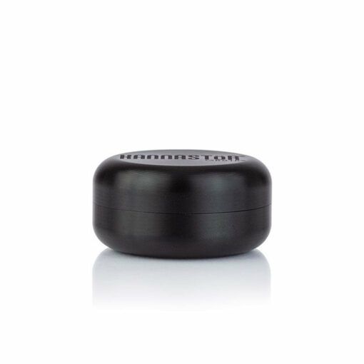 A small, round, matte black RYOT GR8TR SOLID BODY GRINDER container is shown against a white background with the product name printed on the lid.