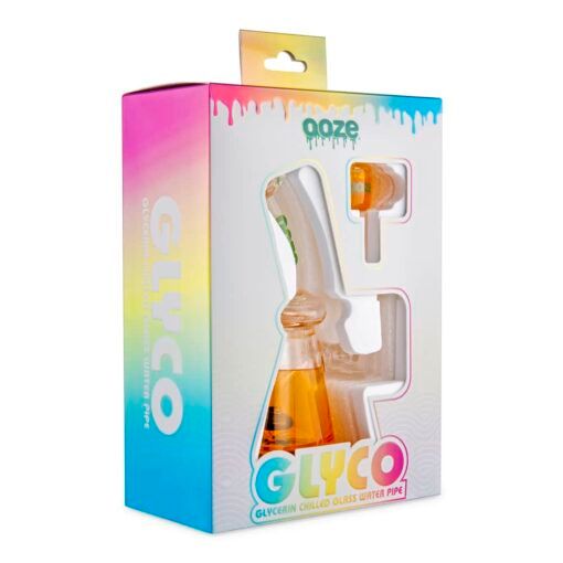 A colorful box with a clear window showcases the Ooze Glyco Bong Glycerin Chilled Glass Water Pipe in orange with a matching bowl. The packaging displays "Ooze" and "GLYCO" in bold letters.