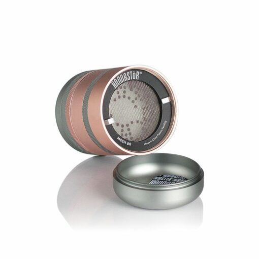 The RYOT GR8TR Solid Body Grinder features a rose gold and gray cylindrical design. The top is labeled Kannastör Mesh 60, shown next to the open bottom with a mesh screen, offering quality comparable to other premium grinders.