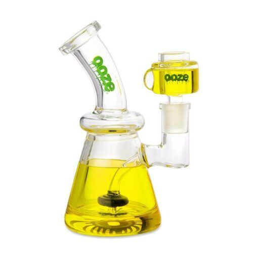 The Ooze Glyco Bong Glycerin Chilled Glass Water Pipe features “ooze” in green on the neck and chamber, both filled with yellow glycerin, plus a wide base and curved mouthpiece for a stylish, chilled smoking experience.