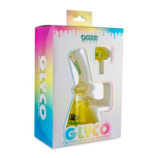 The Ooze Glyco Bong Glycerin Chilled Glass Water Pipe comes boxed in vibrant blue, yellow, and pink gradient packaging with a clear window that displays the pipe and accessories.