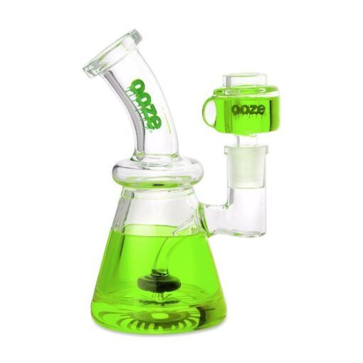 The Ooze Glyco Bong Glycerin Chilled Glass Water Pipe features a clear beaker-shaped base with bright green liquid, a bent neck with the Ooze logo, and a side chamber for chilled hits topped with a matching green lid.