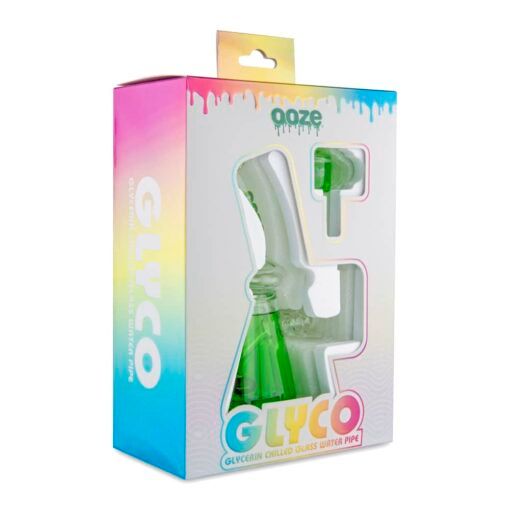 A vibrant retail box with a window showcases the Ooze Glyco Bong Glycerin Chilled Glass Water Pipe. The packaging features "Ooze" branding, a gradient backdrop, and dripping paint accents, highlighting this innovative chilled glass water pipe.