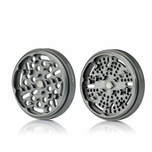 Two RYOT GR8TR SOLID BODY GRINDER metal pieces with multiple holes and sharp teeth are displayed side by side on a white background.