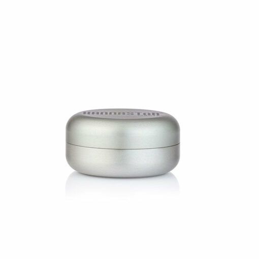 A compact, round, silver RYOT GR8TR SOLID BODY GRINDER with a flat base and rounded lid engraved with "Kannastor" rests on a plain white background.