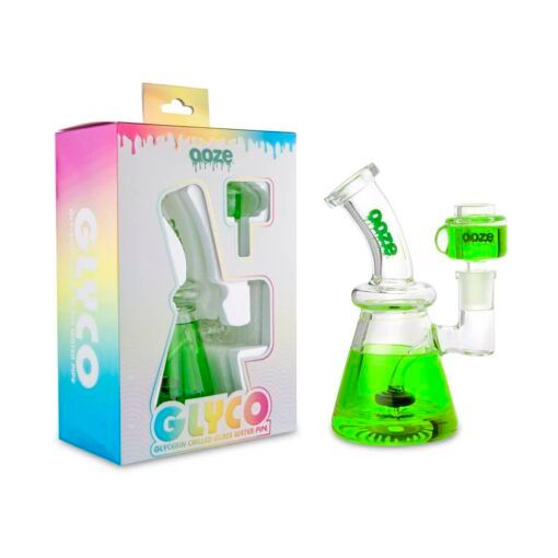 The Ooze Glyco Bong Glycerin Chilled Glass Water Pipe, shown in green, appears beside its colorful retail box and contains bright green liquid for a refreshing, glycerin-cooled experience.
