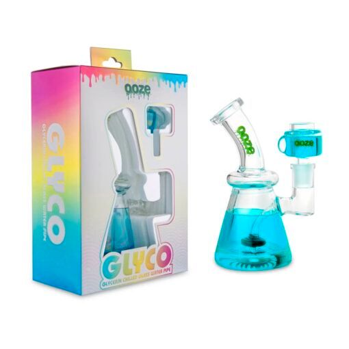 A blue liquid-filled Ooze Glyco Bong Glycerin Chilled Glass Water Pipe sits by its colorful GLYCO box. The set features a matching blue accessory, highlighting the bong’s eye-catching, chilled glass design.