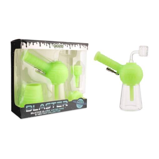 A neon green Ooze Blaster Silicone Glass 4-in-1 Hybrid Water Pipe and Dab Straw is shown next to its box, which features images of the device, dab straw, and included accessories.