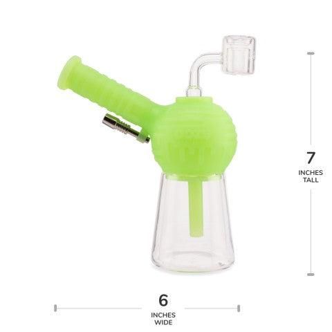 The Ooze Blaster Silicone Glass 4-in-1 Hybrid Water Pipe and Dab Straw is a small, green and clear piece with a bent mouthpiece, metal attachment, and clear bowl. It measures 7" tall by 6" wide and is shown on a white background with measurement indicators.