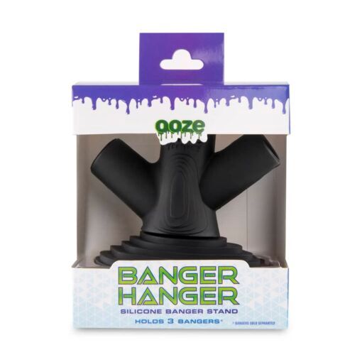 The Ooze Banger Hanger Silicone Banger Stand is black with three angled holders, and comes in a white box with a purple lid, clear front window, and green Ooze branding above the Banger Hanger text.