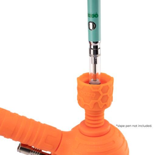 An orange Ooze Blaster Silicone Glass 4-in-1 Hybrid Water Pipe and Dab Straw holds a teal vape pen upright. The text near the bottom right reads, *Vape pen not included. The background is white.