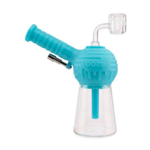 The Ooze Blaster Silicone Glass 4-in-1 Hybrid Water Pipe and Dab Straw features a blue and clear silicone body, cylindrical base, round blue top, side handle, glass top attachment, and "ooze" embossed on the silicone.