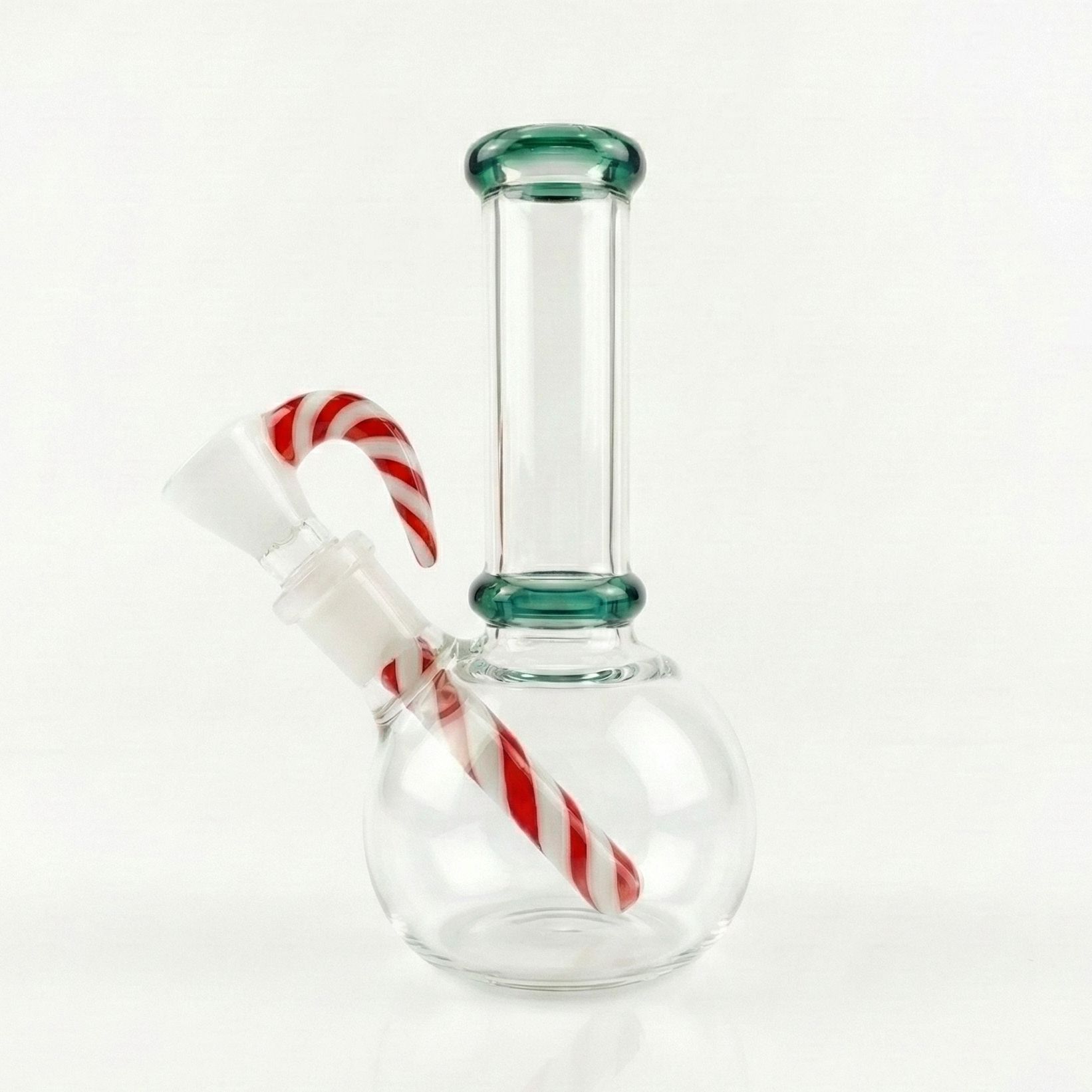 The Peppermint Swirl Bong features a clear glass body, green accents, and a candy cane-shaped stem with red and white stripes, making it stand out against a plain white background.