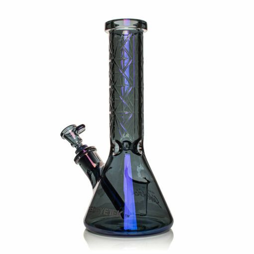The Gear Premium 12" Sidekick Beaker (Terminator Finish) Water Pipe is a glass piece with an iridescent Terminator finish, a straight neck with geometric designs, side-mounted bowl, and a wide base for added stability.