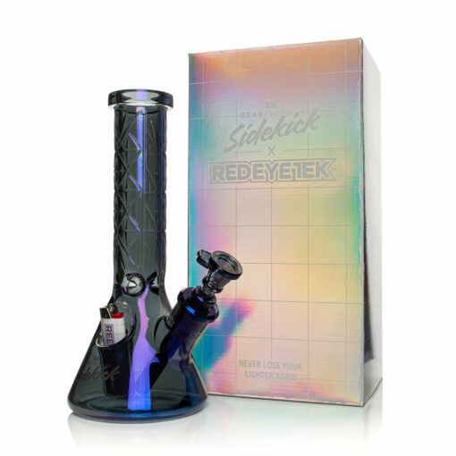 A blue glass Gear Premium 12" Sidekick Beaker (Terminator Finish) Water Pipe with a lighter in its holder sits in front of a shiny holographic box that reads, "Never lose your lighter again—crafted for GEAR Premium fans.