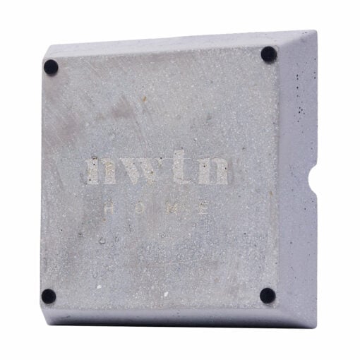 The NWTN Home Roseland Set Ashtray is a square concrete piece with rounded edges, four small black corner pads, "nwtn HOME" engraved on the front, and a curved indentation on the right edge.