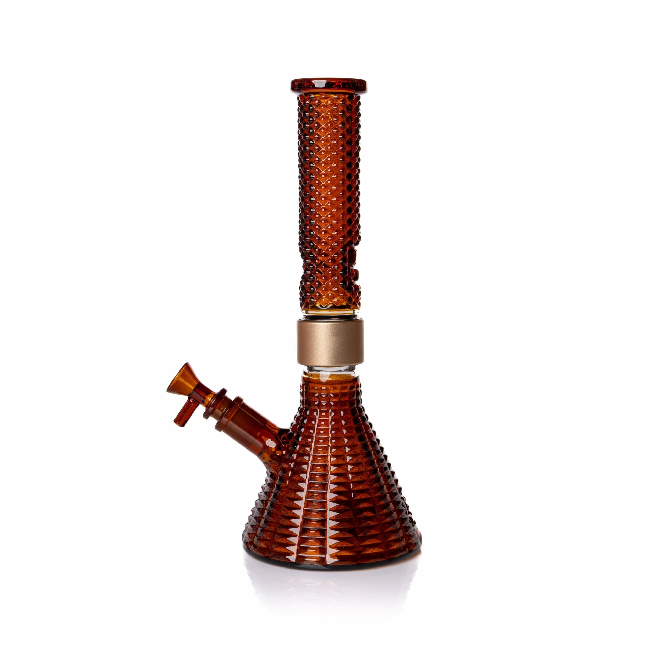 The Jane West x Prism Bong - Amber features a textured patterned surface, beaker base, straight neck, gold ring, and angled mouthpiece—an elegant piece set against a white background.