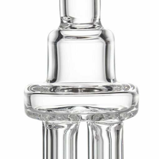 Close-up of the MJ Arsenal Tetra dab rig, featuring smooth cylindrical shapes and rounded edges. Reflections highlight its transparent glass, emphasizing the Tetra's superior texture and clarity.