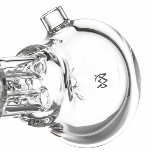 Close-up view of the base of the MJ Arsenal Tetra clear glass dab rig, featuring a small etched logo on the glass surface.