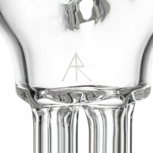 Close-up of the base of the MJ Arsenal Tetra, a clear glass piece featuring a geometric logo with overlapping A and R letters etched onto its smooth, reflective surface—exemplifying Tetra’s modern design.
