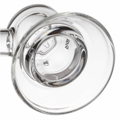A close-up of the MJ Arsenal Grotto Glass Pipe showcases its clear, smooth, curved glass and reflective surface, photographed against a white background.