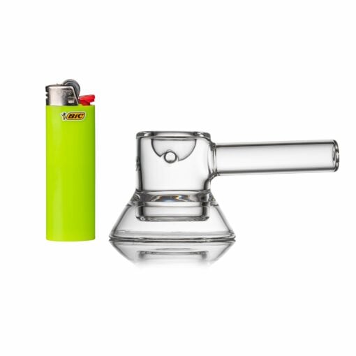 A green Bic lighter stands upright beside a small, clear MJ Arsenal Grotto Glass Pipe with a wide base and short straight mouthpiece, both displayed against a white background.