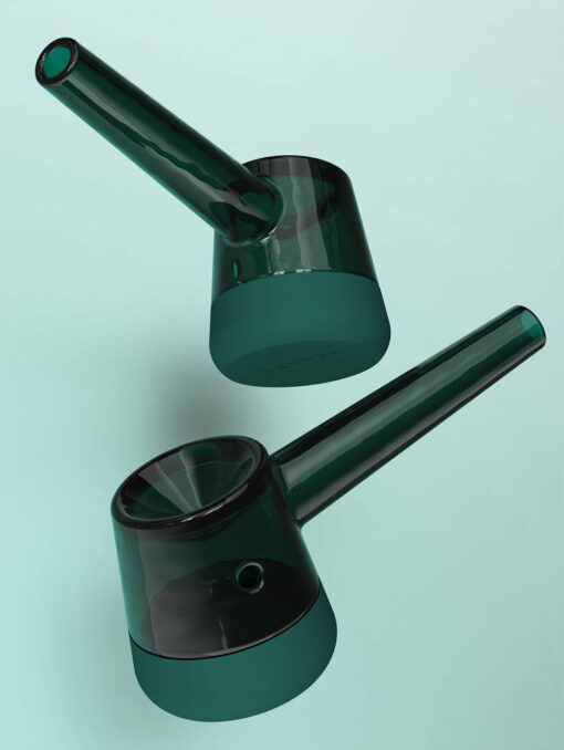 Two Forge [Emerald] glass pipes feature cylindrical bases and angled stems, arranged diagonally on a light teal background. Their sleek, minimalist design emphasizes clean lines and smooth, emerald-toned surfaces.