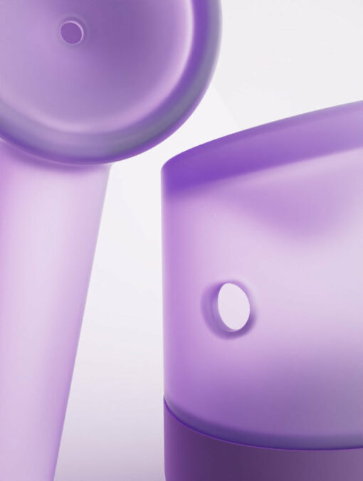 Close-up of two Forge [Lilac] translucent cylinders with circular holes, set against a light background. Their smooth surfaces and soft lighting create an abstract, minimalistic composition.